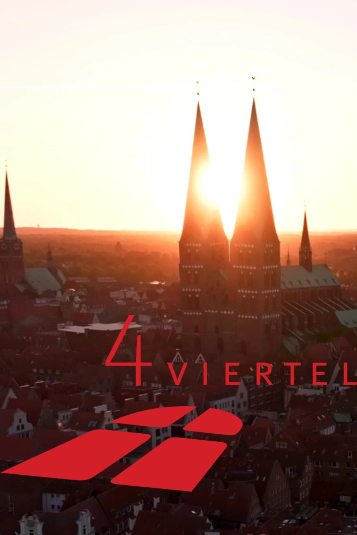 St. Marien im Sonnenaufgang mit dem Logo der 4-Viertel-Stiftung